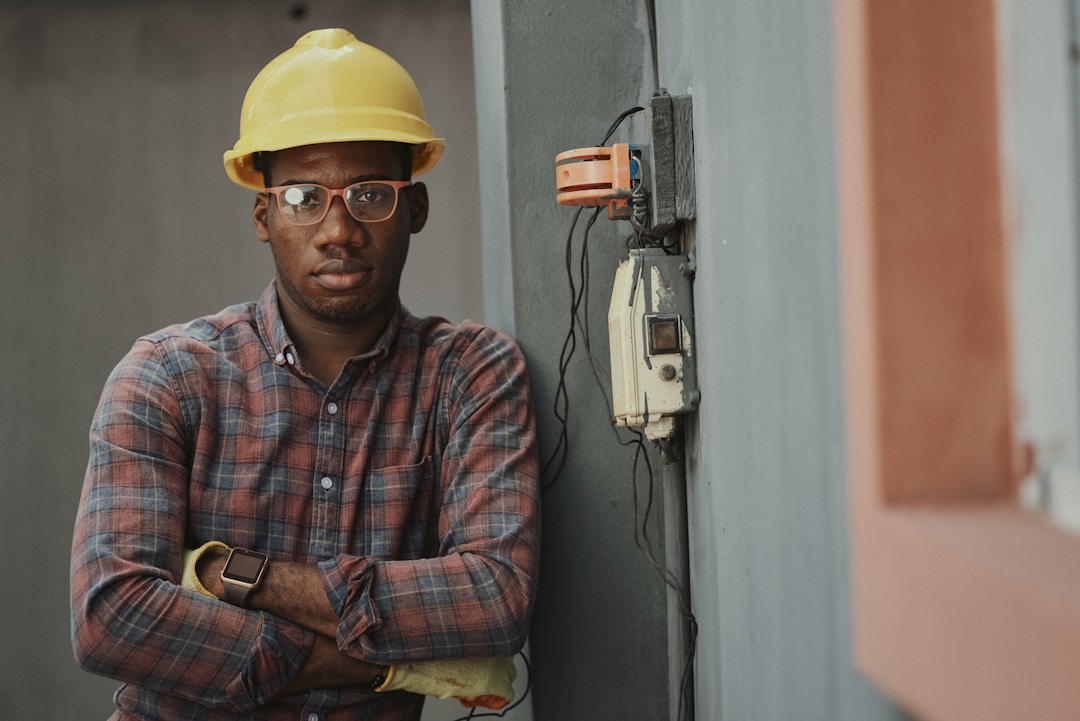 HVAC technician performing maintenance on air conditioning unit with tools and equipment