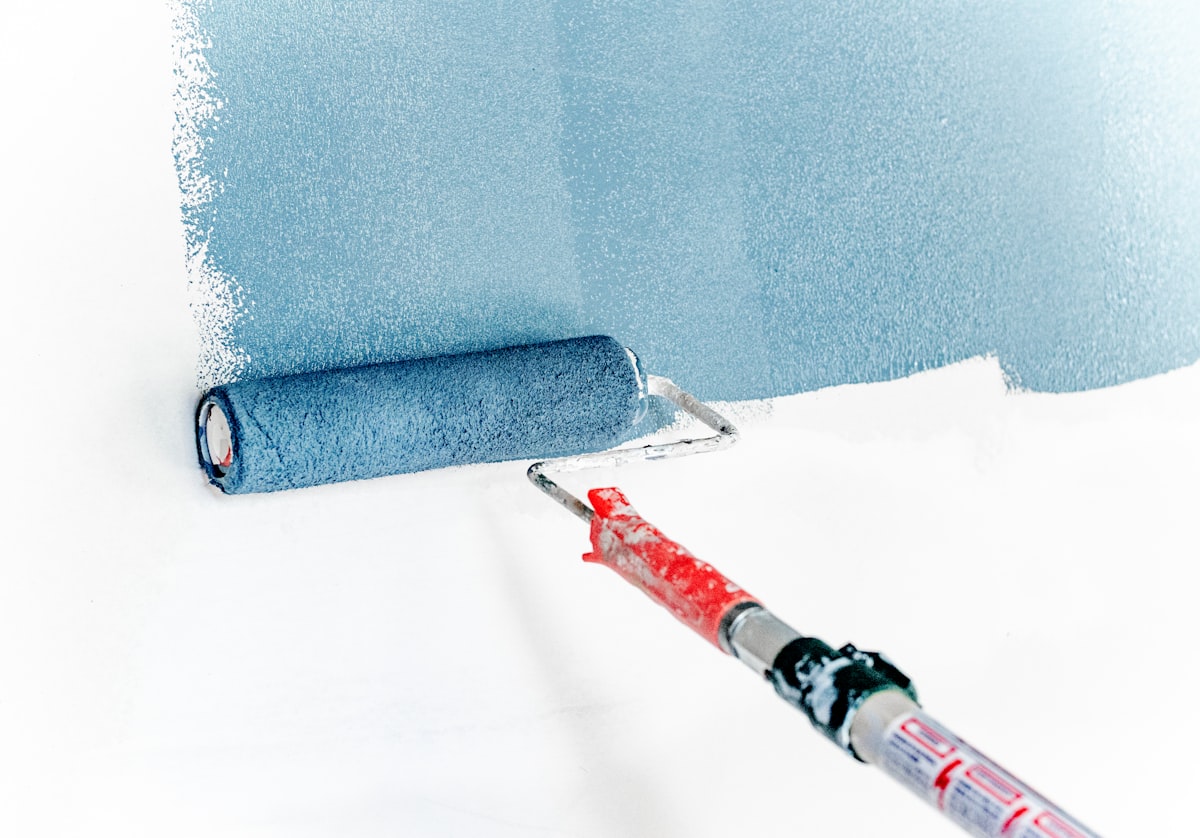 Professional painting contractor working on interior wall in Abu Dhabi